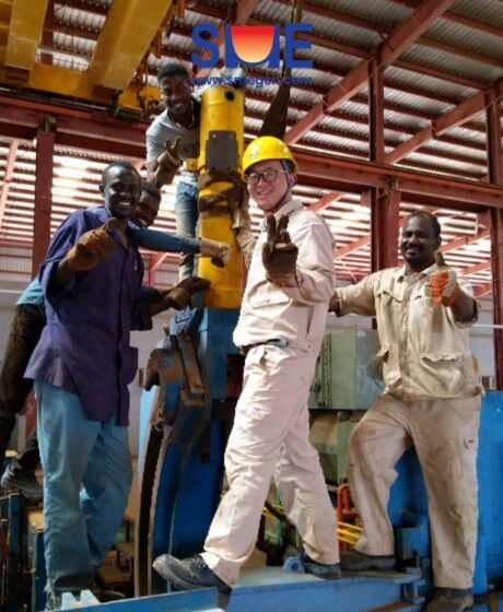 A young SME Worker took photo with local workers near the rolling mill, showing the friendship between the two partners.