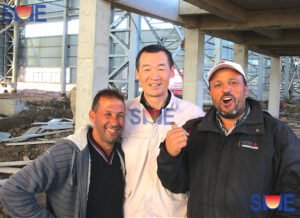 Group photo of SME engineer and local workers with joys on their faces